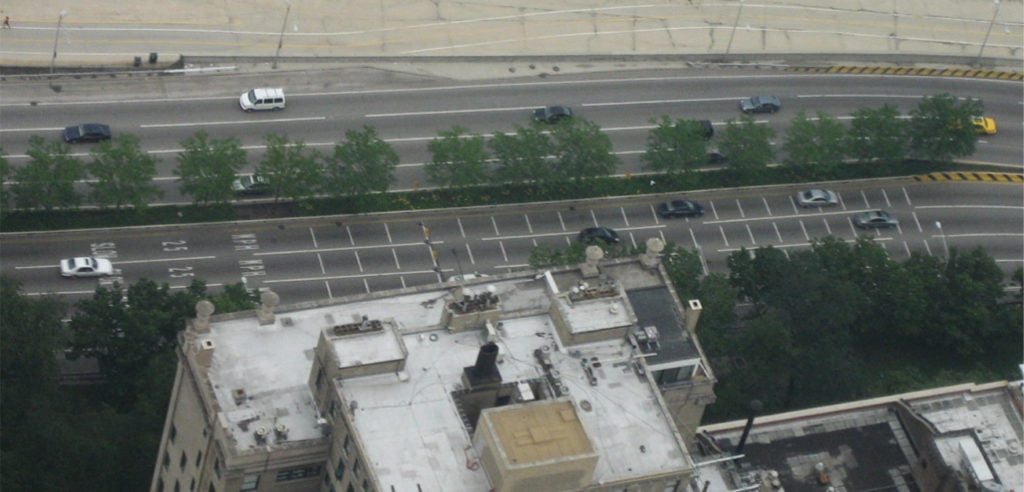 White lines gradually getting closer together as drivers approach the sharpest point of the curve